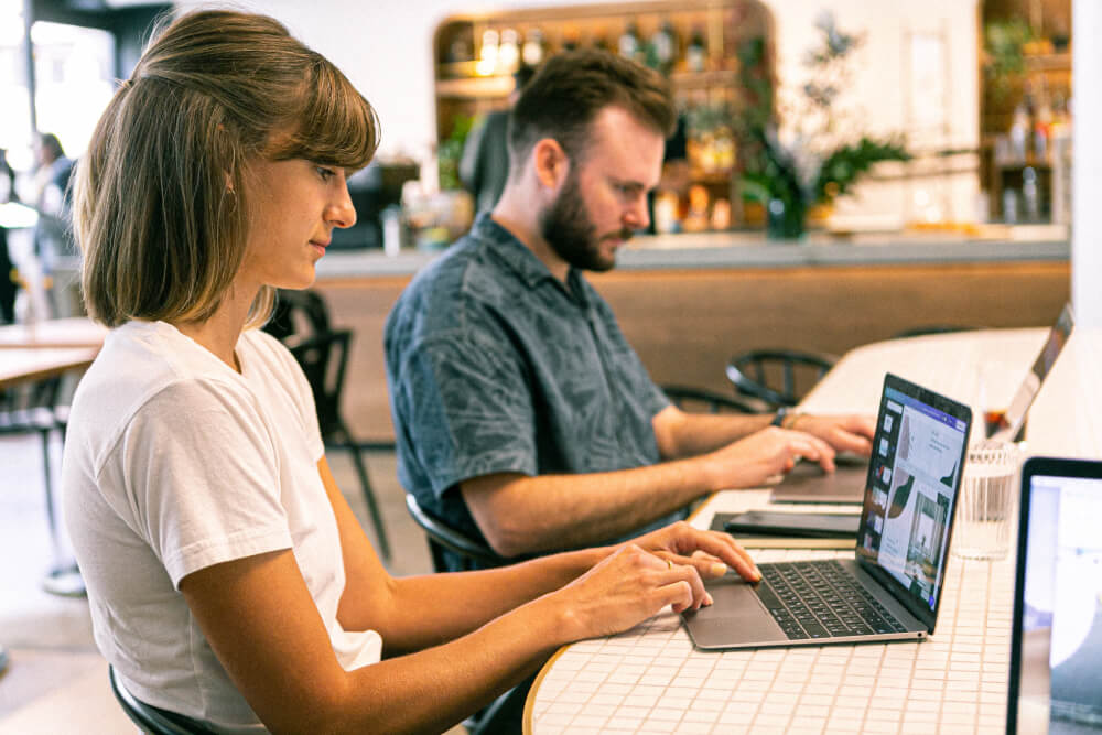 Young men and women working on laptop in Digital Root Media's office