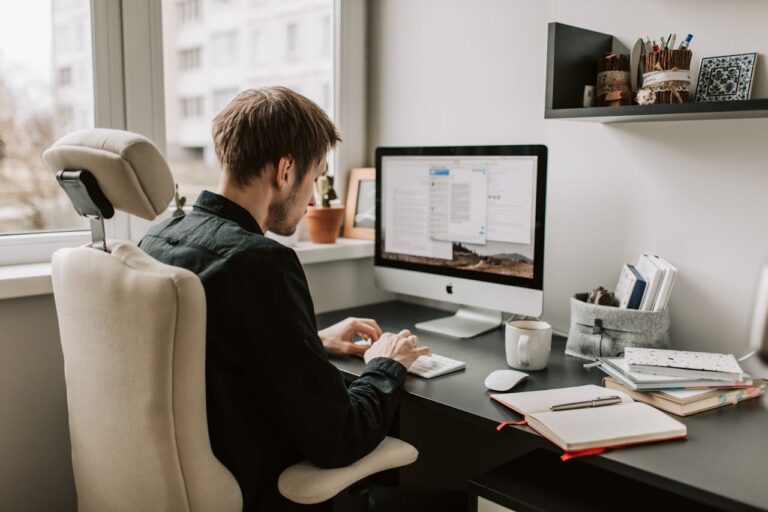 A digital marketer analyzing mobile SEO metrics on a smartphone and laptop, emphasizing the importance of mobile optimization for search rankings.