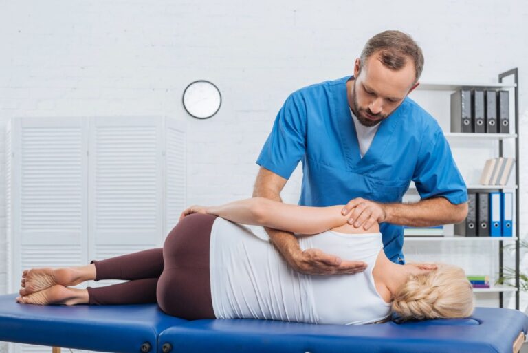 Chiropractor treating a patient's back on a treatment table