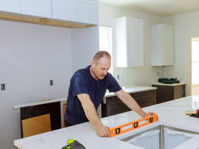 Countertop company website design: installer leveling a new kitchen countertop