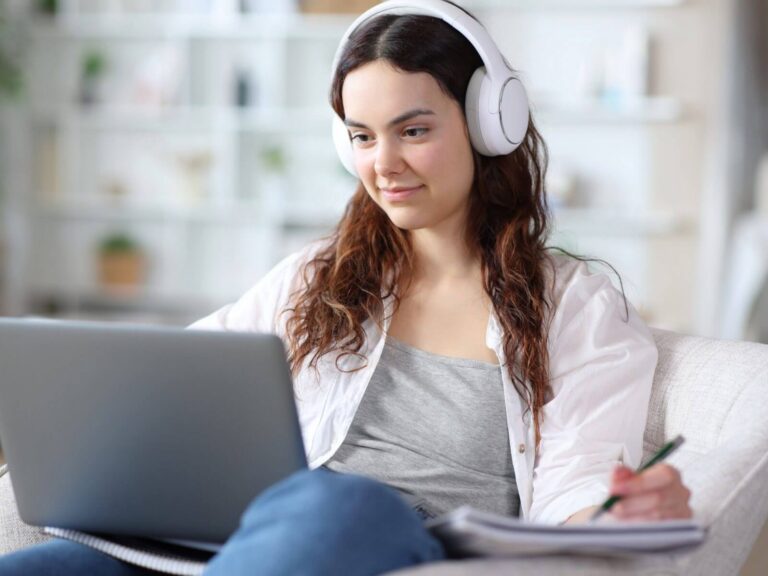 Online course website design: student with headphones taking an online course on a laptop