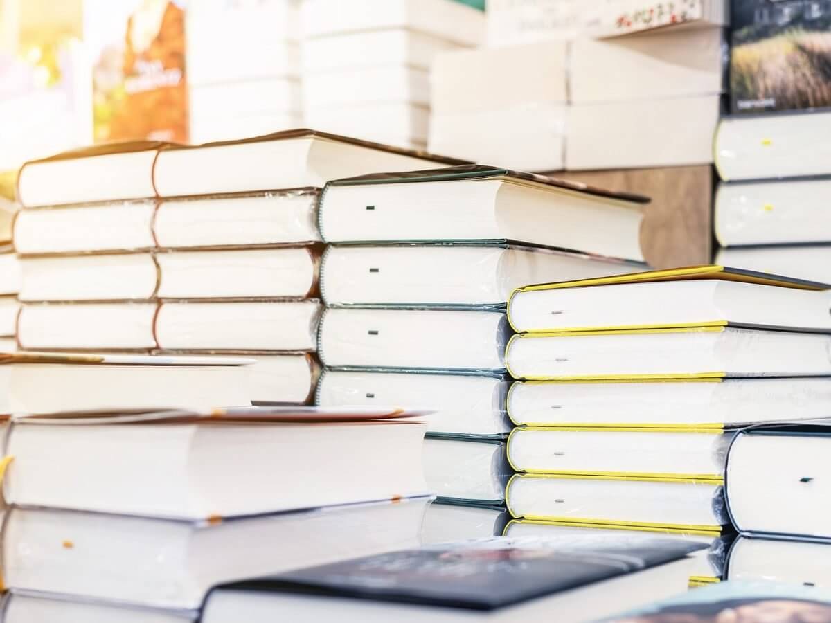Publishing company website design: stacks of freshly printed hardcover books ready for release