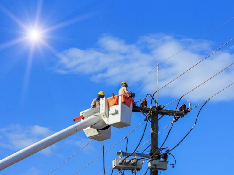 Utility company website design: lineworker repairing power lines from a bucket truck