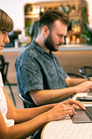 Person typing on a laptop with SEO analytics, keyword research tools, and content strategy notes on the screen, representing SEO-friendly blog writing.
